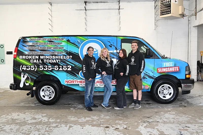The Northern Glass Pros team standing in front of the company van.