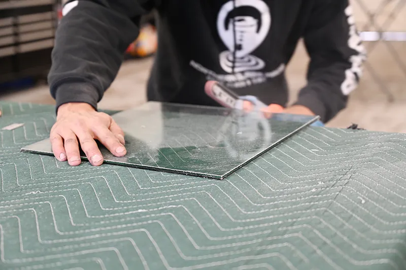 Glass repair tec inspecting a piece of glass.
