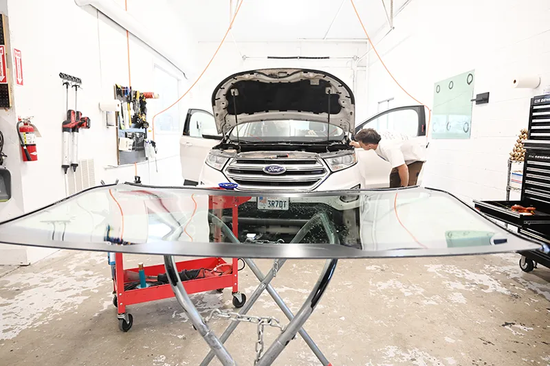 Pickup truck in the shop having the windshield replaced.