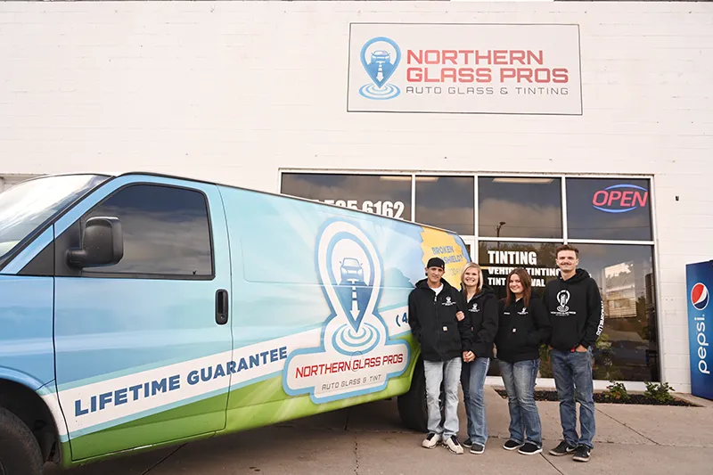 Northern Glass Pros team standing in front of company van.