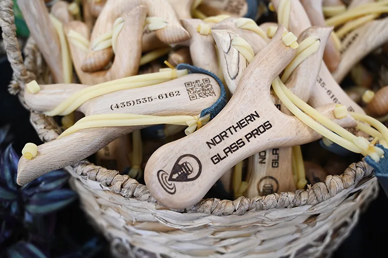 Basket of slingshots with Northern Glass Pro logo burned into the handle.