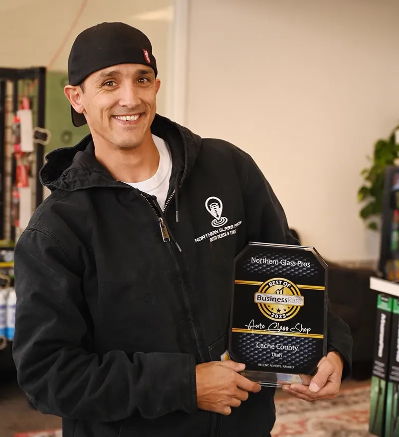 Owner of Northern Glass Pros holding up a Best of 2025 business award.