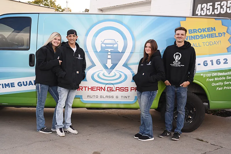 Northern Glass Pros team standing in front of the company van.