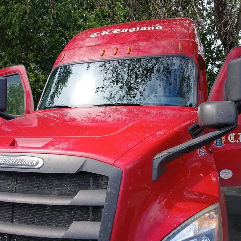 Red ford diesel truck with a shiny new window.